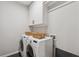 Laundry room featuring a washer, dryer, and storage cabinets for organization at 3445 Henderson Dr, Cumming, GA 30041