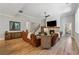 Spacious living room with fireplace, hardwood floors, and stairs to the second floor at 3445 Henderson Dr, Cumming, GA 30041