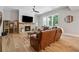 Cozy living room with a brick fireplace, hardwood floors, and ample seating at 3445 Henderson Dr, Cumming, GA 30041