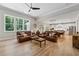 Open-concept living room featuring hardwood floors and abundant natural light at 3445 Henderson Dr, Cumming, GA 30041