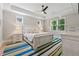 Spacious main bedroom featuring a tray ceiling, plush bedding, and natural light at 3445 Henderson Dr, Cumming, GA 30041