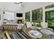Cozy porch with fireplace, dining table, and views of backyard at 3445 Henderson Dr, Cumming, GA 30041