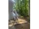 View of back deck and stairs to home surrounded by green foliage and a wood fence at 72 Victorian Cir, Dallas, GA 30157