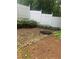 Backyard with rocks, mulch, and a white vinyl fence at 72 Victorian Cir, Dallas, GA 30157
