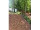 Lawn with lush green trees, plants, and a wood fence in the backyard at 72 Victorian Cir, Dallas, GA 30157