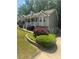 Charming gray home with landscaped yard, flowering shrubs, and a well-manicured lawn with a view of the driveway at 72 Victorian Cir, Dallas, GA 30157