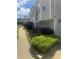 Two story gray home with lush landscaping, including a fountain and verdant foliage along a cozy side walkway at 72 Victorian Cir, Dallas, GA 30157
