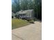 Charming two-story home with gray siding, landscaped yard, and inviting front porch and a view of the driveway at 72 Victorian Cir, Dallas, GA 30157