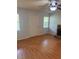 Light-filled living room with hardwood floors, stone fireplace, ceiling fan, and bright windows enhancing the space at 72 Victorian Cir, Dallas, GA 30157