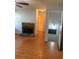 Inviting living room showcasing hardwood floors, a stone fireplace, and an open doorway leading to additional rooms at 72 Victorian Cir, Dallas, GA 30157