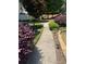 Lush landscaping with a fountain, verdant shrubs, and stone edging detail enhance the curb appeal of this home at 72 Victorian Cir, Dallas, GA 30157