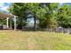 Backyard with large tree and partial view of deck at 870 Underhill Ct, Sugar Hill, GA 30518