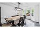 Bright dining room featuring a modern chandelier, wainscoting, and a bay window at 870 Underhill Ct, Sugar Hill, GA 30518