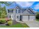 Charming two-story home with a well-manicured lawn, beautiful landscaping, and an attached two-car garage at 870 Underhill Ct, Sugar Hill, GA 30518