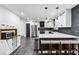 Modern kitchen featuring an island with seating, stainless steel appliances and a stone backsplash at 870 Underhill Ct, Sugar Hill, GA 30518
