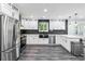 Beautiful kitchen boasts white cabinets, stainless steel appliances, and stylish countertops at 870 Underhill Ct, Sugar Hill, GA 30518