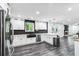 Open kitchen featuring white cabinets, a stone backsplash, and stainless steel appliances with an open floorplan at 870 Underhill Ct, Sugar Hill, GA 30518