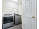 Laundry room with grey washer and dryer at 870 Underhill Ct, Sugar Hill, GA 30518