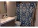 Updated bathroom featuring a modern vanity, sink, and stylish blue patterned shower curtain at 2814 Shellbark Rd, Decatur, GA 30035