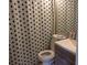 This bathroom has a blue and white patterned shower curtain, a sink, mirror, and toilet at 2814 Shellbark Rd, Decatur, GA 30035