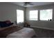 Bright bedroom featuring a ceiling fan, multiple windows, and neutral decor at 2814 Shellbark Rd, Decatur, GA 30035