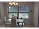 A modern dining room with a white table set and large window with natural light at 2814 Shellbark Rd, Decatur, GA 30035