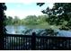 A scenic lake view from a wooden porch, surrounded by lush green trees at 2814 Shellbark Rd, Decatur, GA 30035