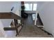 View from the top of the stairs, looking down into a living room with hard wood floors and a chair at 2814 Shellbark Rd, Decatur, GA 30035