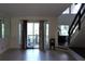 Bright living room with tile floors, sliding glass doors to a porch, and staircase at 2814 Shellbark Rd, Decatur, GA 30035