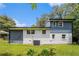 A spacious backyard, mature trees, and a blue and white exterior provide comfort and charm at 479 Charter Oak Sw Dr, Atlanta, GA 30331