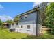 This home features a spacious backyard, mature trees, and blue and white exterior at 479 Charter Oak Sw Dr, Atlanta, GA 30331