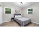 This bedroom features natural light, modern decor, hardwood-look flooring, and a comfortable bed at 479 Charter Oak Sw Dr, Atlanta, GA 30331