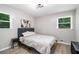 Bright bedroom with modern lighting, wood-look flooring, and sunny windows at 479 Charter Oak Sw Dr, Atlanta, GA 30331