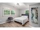 Comfortable bedroom featuring wood-look floors, bright windows, chair and stylish decor at 479 Charter Oak Sw Dr, Atlanta, GA 30331