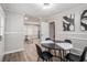 Dining area showcases a striking black and white table, modern lighting, and views into the living room at 479 Charter Oak Sw Dr, Atlanta, GA 30331