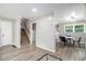 Open-concept dining area featuring stylish table and chairs, seamlessly connecting to the stairway and living spaces at 479 Charter Oak Sw Dr, Atlanta, GA 30331