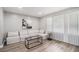 Sun-lit living room showcases a comfortable couch, modern glass table, and bright window with blinds at 479 Charter Oak Sw Dr, Atlanta, GA 30331