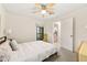 Cozy bedroom with neutral palette featuring a ceiling fan and a glimpse of the kitchen at 1424 Tuxworth Cir, Decatur, GA 30033