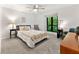 Serene bedroom featuring a large window with wooded views, ceiling fan, and neutral decor at 1424 Tuxworth Cir, Decatur, GA 30033