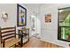 Hallway featuring decorative paintings, a table with a wine rack, hardwood floors and a large window at 1424 Tuxworth Cir, Decatur, GA 30033
