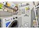 Functional laundry room with modern washer and dryer, ample shelving for storage, and organized utility systems at 1424 Tuxworth Cir, Decatur, GA 30033