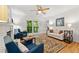 Bright living room with hardwood floors, fireplace, and sliding glass doors opening to the outdoor balcony at 1424 Tuxworth Cir, Decatur, GA 30033