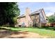 Spacious backyard featuring a well-maintained lawn, privacy fence, and mature trees offering a peaceful retreat at 1890 Turtle Creek Way, Lawrenceville, GA 30043
