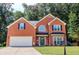 Charming red brick home with manicured lawn, black shutters, and a two-car garage at 1890 Turtle Creek Way, Lawrenceville, GA 30043