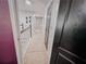 Hallway featuring neutral carpet, railing, and doorways to other rooms at 1890 Turtle Creek Way, Lawrenceville, GA 30043