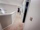 Light and airy hallway with neutral carpet and fresh paint, leading to bedrooms and living areas at 1890 Turtle Creek Way, Lawrenceville, GA 30043