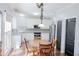 Bright, white kitchen featuring stainless steel appliances, granite countertops, and a dining area at 1890 Turtle Creek Way, Lawrenceville, GA 30043