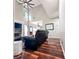 Inviting living room featuring a fireplace, ceiling fan, and hardwood floors at 1890 Turtle Creek Way, Lawrenceville, GA 30043