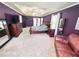 Elegant main bedroom with tray ceilings, a sitting area, and stylish decor, offering a relaxing retreat at 1890 Turtle Creek Way, Lawrenceville, GA 30043