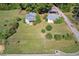 Aerial shot showing a lot with existing buildings, grassy areas, and surrounding foliage at 21 Elm St, Hampton, GA 30228